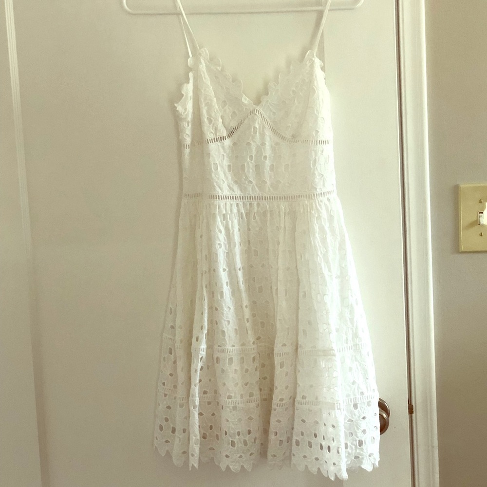 Bebe White lace cutout dress.